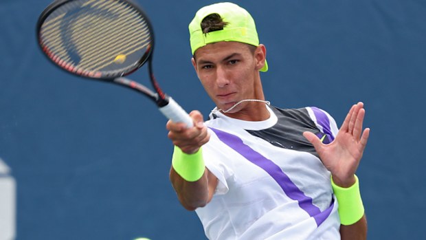 Alexei Popyrin of Australia returns a shot against Federico Delbonis