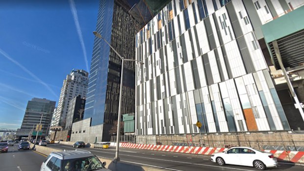 The apartment building with the glass exterior has been subjected to mysterious shootings, with bullets smashing into apartment living rooms