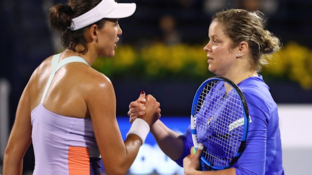  Garbine Muguruza of Spain is congratulated by Kim Clijster of Belguim against after winning her Women's Singles match on Day One of the Dubai Duty Free Tennis Championships 