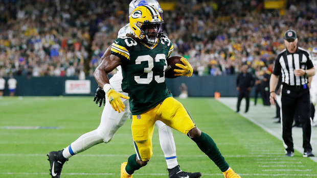  Aaron Jones #33 of the Green Bay Packers scores a touchdown against the Detroit Lions during the second half at Lambeau Field on September 20, 2021 in Green Bay, Wisconsin. (Photo by Wesley Hitt/Getty Images)