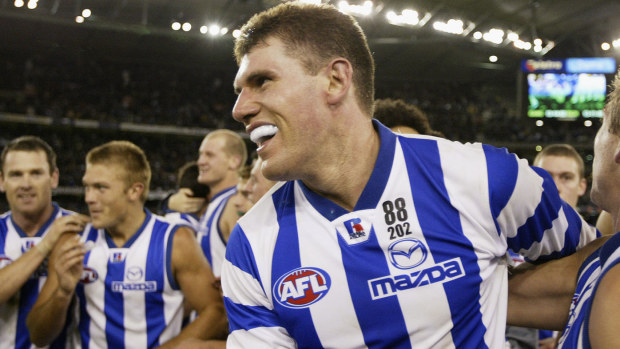 Jason McCartney #5 of the Kangaroos is congratulated by teammates after the Kangaroos defeated the Tigers