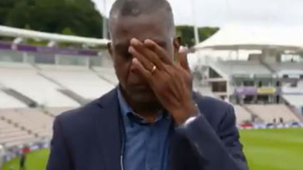 Michael Holding wipes away tears during a live interview discussing racism.
