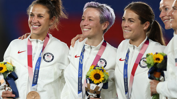 Bronze medalists Carli Lloyd , Megan Rapinoe and Kelley O'Hara of Team United States (C) react with their bronze medal