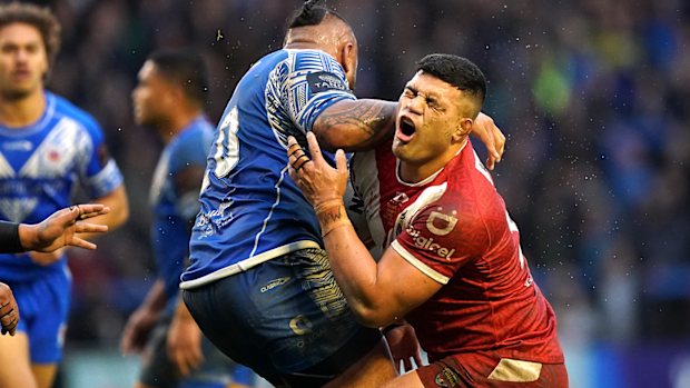 Tonga's David Fifita is tackled by Samoa's Junior Paulo during their Rugby League World Cup quarterfinal.