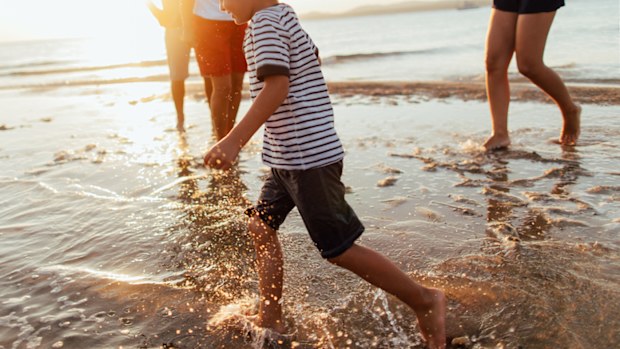 A child playing at the beach
