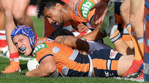 Kalyn Ponga of the Knights scores a try during the Round 10