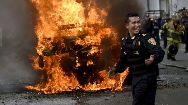 Firefighters and police officers at the scene of a shoot-out in which eight alleged drug traffickers were shot dead by Mexican Navy officers in Tlahuac, Mexico City. (AFP)