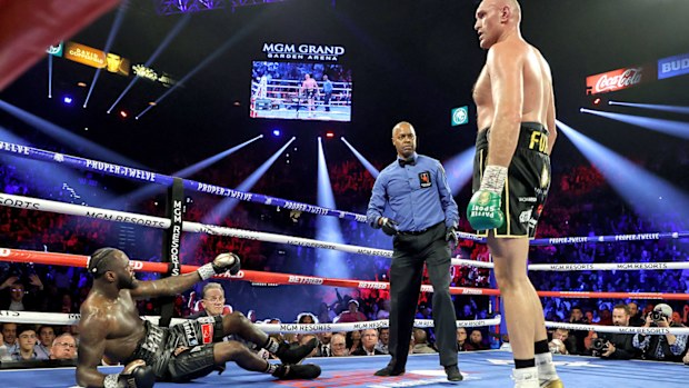 Tyson Fury knocks down Deontay Wilder in the third round during their Heavyweight bout for Wilder's WBC and Fury's lineal heavyweight title