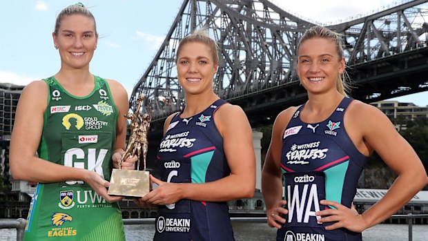 West Coast Fever captain Courtney Bruce and Melbourne Vixens co-captains Kate Moloney and Liz Watson pose with the Super Netball trophy