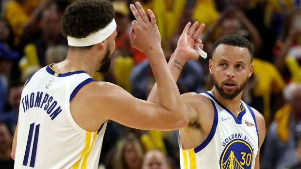 Stephen Curry #30 and Klay Thompson #11 of the Golden State Warriors celebrate