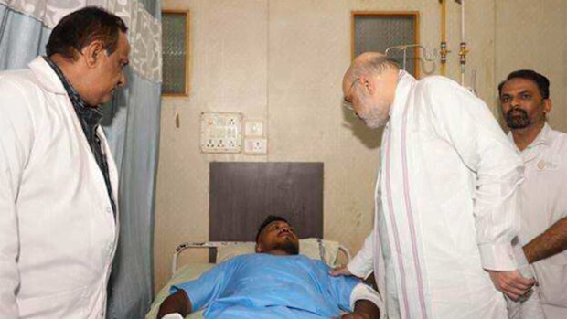 Indian Home Affairs Minister Amit Shah meeting British plane crash survivor Vishwash Kumar Ramesh.