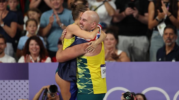 Nina Kennedy and Matt Denny embrace on a sparkling night for Australia's athletics team.