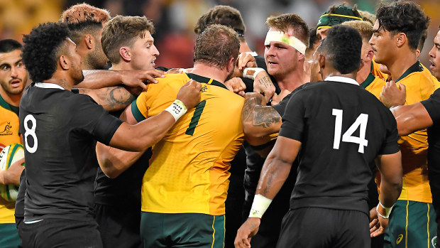 James Slipper of the Wallabies and Sam Cane of the All Blacks confront each other