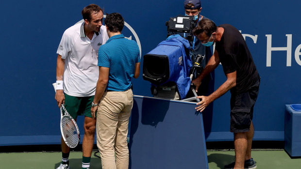 Daniil Medvedev of Russia speaks to chair umpire Nacho Forcadell after colliding with a television camera in his match against Andrey Rublev of Russia during the semifinals of the Western & Southern Open at Lindner Family Tennis Center on August 21, 2021 in Mason, Ohio. (Photo by Matthew Stockman/Getty Images)