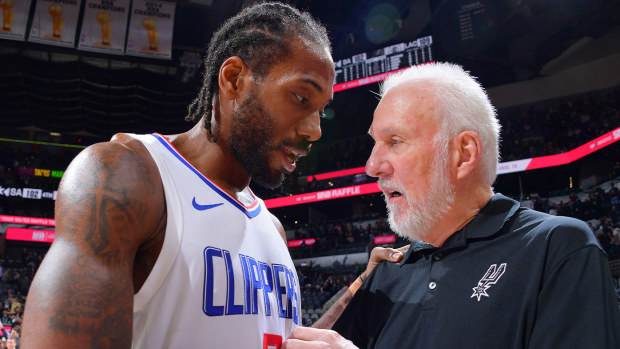 Kawhi Leonard shares an embrace with his old coach Gregg Popovich after the game