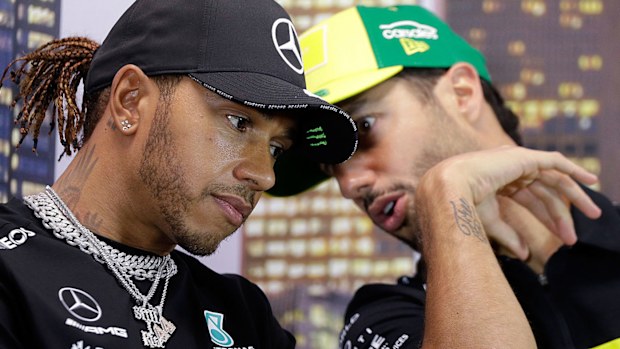 Mercedes driver Lewis Hamilton of Britain and Renault driver Daniel Ricciardo of Australia, right, talk during a press conference at the Australian Formula One Grand Prix 