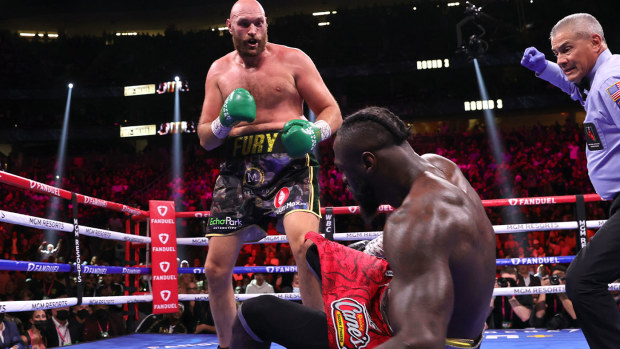  Tyson Fury (L) knocksdown Deontay Wilder (R) during their fight for the WBC heavyweight championship 