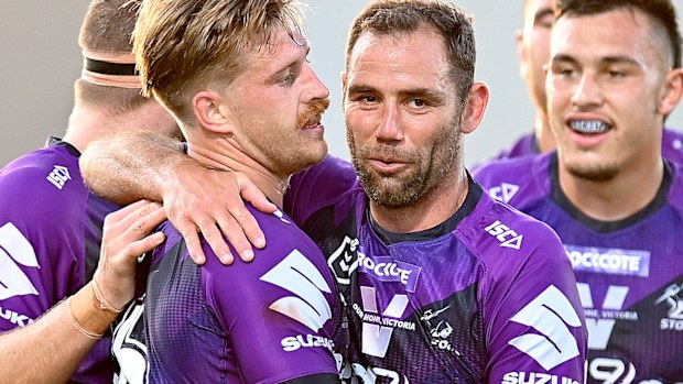 Cameron Munster of the Storm is congratulated by Cameron Smith after scoring a try