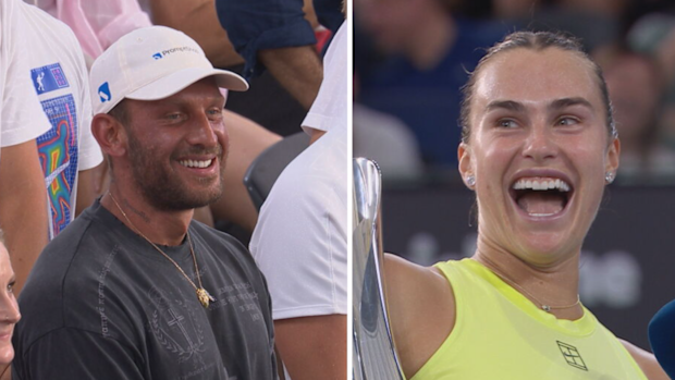 Aryna Sabalenka laughs while speaking to the crowd.