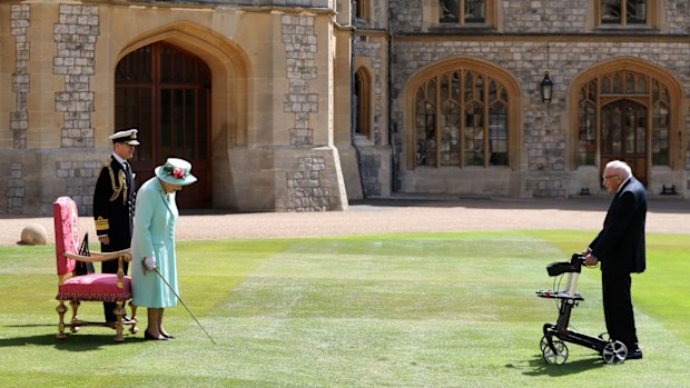 Queen Elizabeth II awards Captain Sir Thomas Moore with the insignia of Knight Bachelor at Windsor Castle on July 17, 2020 in Windsor, England.