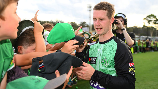 Sam Harper of the Melbourne Stars signs autographs during the BBL match between Melbourne Stars and Sydney Thunder at Lavington Sports Ground, on December 23, 2023, in Albury, Australia. (Photo by Morgan Hancock/Getty Images)