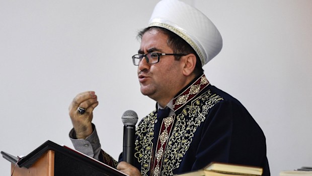 Iman Fevzi Hocuk talks to muslim believers in a mosque after the shooting in Hanau, Germany, Friday, Feb. 21, 2020