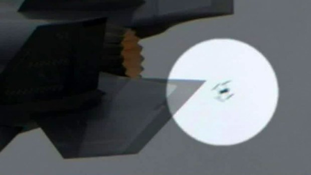 The tiny unmanned aircraft was so close to the fifth-generation fighter it was flung aside by the jet wash