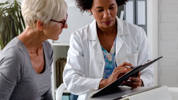 Woman having check-up with doctor.