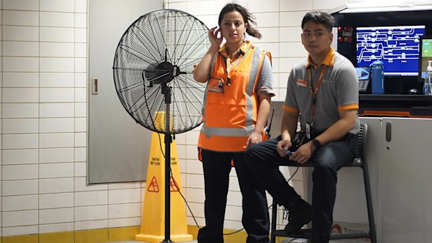 Train station staff stay in front of a fan. Photo: Dion Georgopoulos / The Sydney Morning Herald