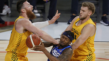 Bradley Beal of the US drives into Aron Baynes of the Australia Boomers as Jock Landale closes in.
