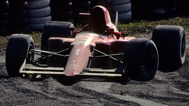 Alain Prost's broken Ferrari lies abandoned in the sand trap after colliding with Ayrton Senna at the 1990 Japanese Grand Prix.