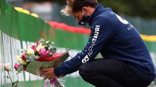 Formula One driver Pierre Gasly lays flowers at the site of Anthoine Hubert's fatal accident.
