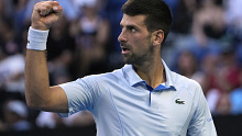 Novak Djokovic of Serbia reacts during his quarterfinal against Taylor Fritz of the U.S. at the Australian Open tennis championships at Melbourne Park, Melbourne, Australia, Tuesday, Jan. 23, 2024. (AP Photo/Andy Wong)