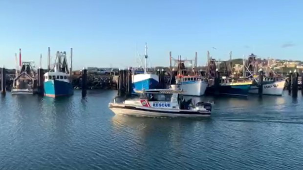 A police boat moves into Coffs Harbour after a so-far unsuccessful search for the two missing fishermen.