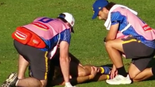 Jamie Cripps holding his knee.