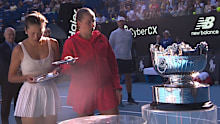 Jelena Ostapenko spots an issue with the trophies handed to her and Hsieh Suwei during the women's doubles presentation.