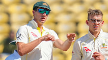 Australia's captain Pat Cummins, left, adjusts fielding as Todd Murphy watches during the third day of the first cricket test match between India and Australia in Nagpur, India, Saturday, Feb. 11, 2023. (AP Photo/Rafiq Maqbool)