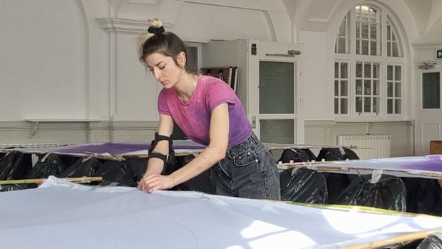 Blandine Blanchard painting bamboo skirts for the Queen's Platinum Jubilee pageant