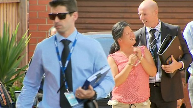 Amy Tran (in pink) smiled after being arrested over the bashing of a 77-year-old woman.