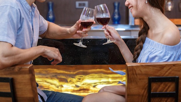 Young Asain Couple Drinking Wine At Bar