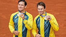 Gold medalists Matthew Ebden and John Peers of Australia celebrate on the podium after defeating Austin Krajicek and Rajeev Ram of the United States in the men's doubles gold medal match at the Roland Garros stadium, at the 2024 Summer Olympics, Saturday, Aug. 3, 2024, in Paris, France. (AP Photo/Manu Fernandez)