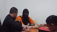Their hands and feet were tied during the proceedings, and their faces were covered with balaclavas.