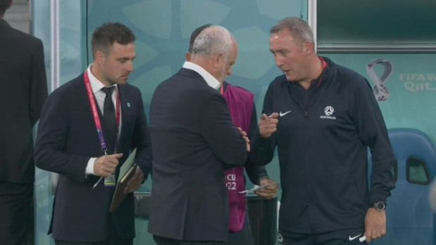 Socceroos coaching staff in discussions holding the Danish note.