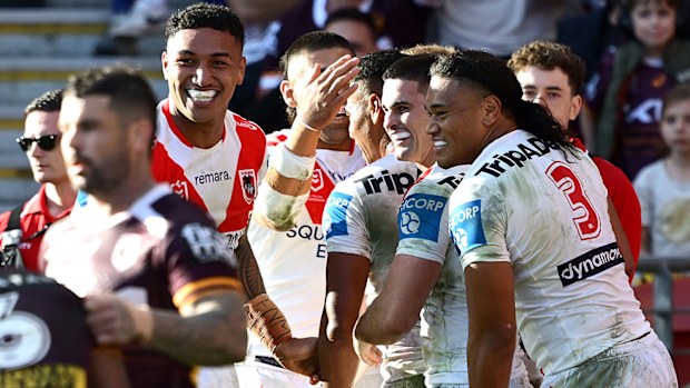 BRISBANE, AUSTRALIA - MAY 31: Setu Tu of the Dragons is congratulated by team mates after scoring a try during the round 13 NRL match between Brisbane Broncos and St George Illawarra Dragons at Suncorp Stadium, on May 31, 2026, in Brisbane, Australia. (Photo by Bradley Kanaris/Getty Images)