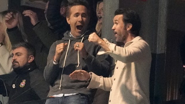 Wrexham co-owners Ryan Reynolds and Rob Mac celebrate after VAR ruled the first Wrexham goal onside.