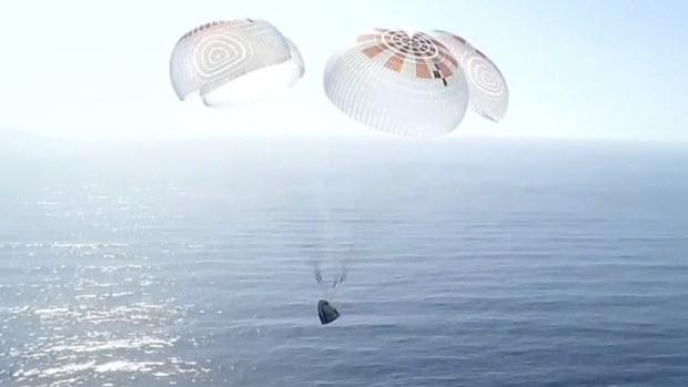 In this image from video provided by SpaceX, a Dragon capsule carrying four space tourists prepares to splash down in the Pacific Ocean off the coast of California on Friday, April 4, 2025. (SpaceX via AP)