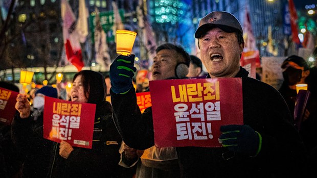 Protesters marched to the presidential office after a candlelight vigil against South Korean President Yoon Suk Yeol in Seoul, South Korea on Thursday, December 5.