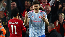 Harry Maguire of Manchester United reacts whilst Mohamed Salah of Liverpool celebrates scoring their side's second goal during the Premier League match between Liverpool and Manchester United at Anfield on April 19, 2022 in Liverpool, England. (Photo by Clive Brunskill/Getty Images)