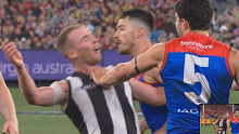 Collingwood's Tom Mitchell flopped to the turf after a soft shove from Christian Petracca.