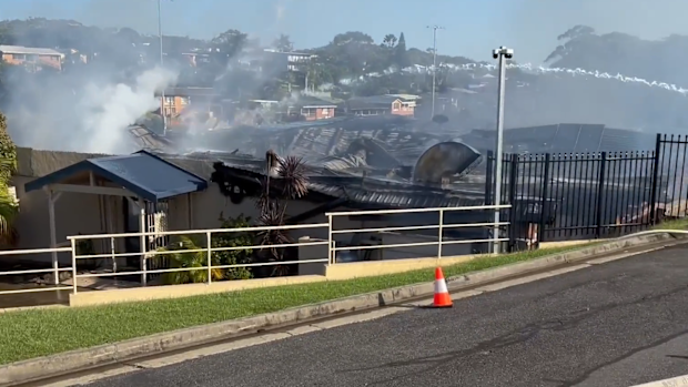 A lack of water supply and several nearby gas cylinders are threatening to worsen a destructive fire that engulfed a beloved sports club in NSW's Mid North Coast.